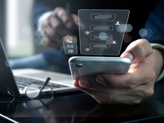 Conversation assistant, digital chatbot, robot application, artificial intelligence (AI), and customer service idea. Man utilizing smart phone with contact us interface and digital chatbot Talk.