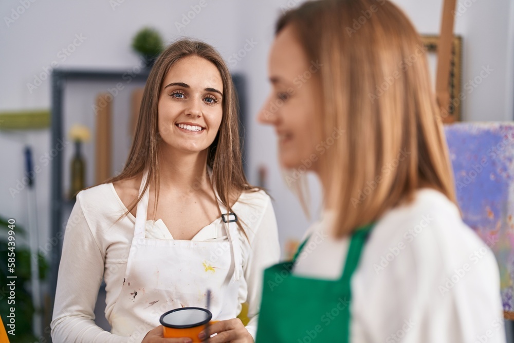 Poster two women artists smiling confident drinking coffee drawing at art studio