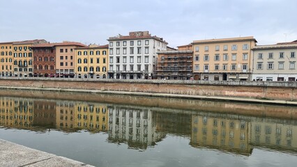 Pisa, Italy - February 25, 2023: View of the medieval town of Pisa from bridge 