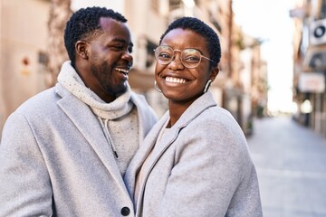 Man and woman couple hugging each other standing at street