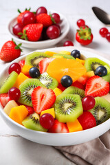 A colourful fruit salad with fresh berries and sliced ​​kiwi