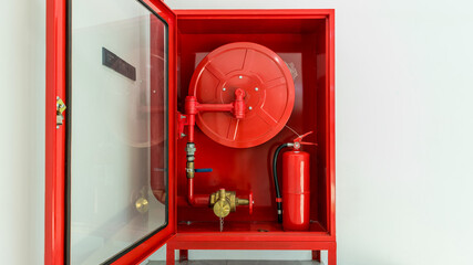 Hydrant with water hoses and fire extinguish equipment. Fire safety equipment in the red box on...