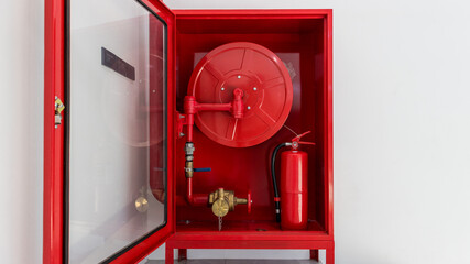 Hydrant with water hoses and fire extinguish equipment. Fire safety equipment in the red box on...