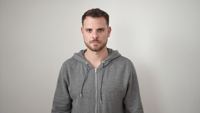 Young Caucasian Man Standing With Serious Expression Wearing Sweatshirt Over Isolated White Background