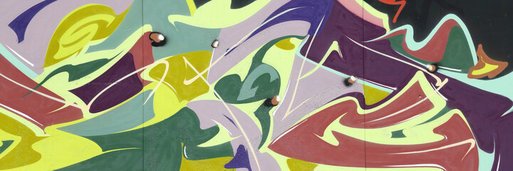 Colorful background of graffiti painting artwork with bright aerosol strips on metal wall. Old school street art piece made with aerosol spray paint cans. Contemporary youth culture backdrop