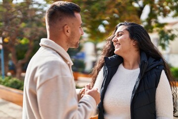 Man and woman couple smiling confident standing together at park