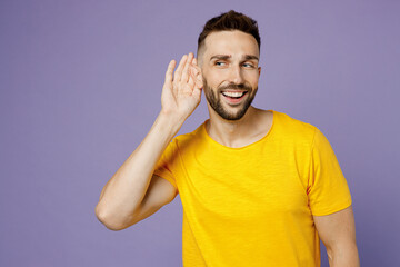 Fototapeta na wymiar Young curious nosy caucasian man wear yellow t-shirt try to hear you overhear listening intently look aside on area isolated on plain pastel light purple background studio portrait. Lifestyle concept.