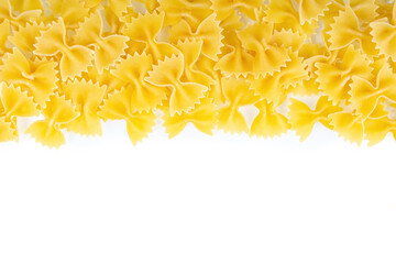 Fototapeta premium Farfalle spaghetti pattern, food background. Scattered raw pasta isolated on white background, ingredient for cook, traditonal italian cuisine. Banner, header, backdrop for restaurant menu