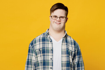 Young smiling fun cheerful happy positive man with down syndrome wearing glasses blue casual...