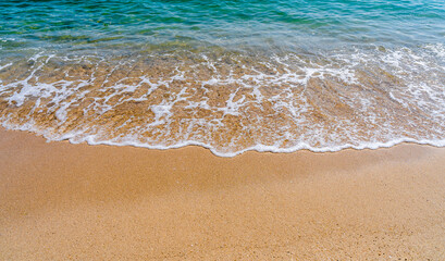 Fototapeta na wymiar waves on the sand beach