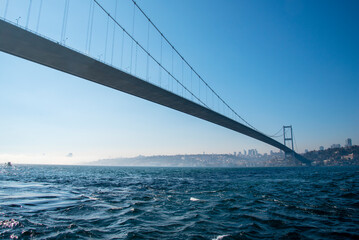 The Bosphorus Bridge across the Strait on a sunny and foggy day.