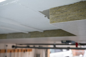 Insulation panels made of mineral wool, which were glued under a basement ceiling