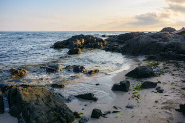ozy sea beach with sand and rocks at sunrise. beautiful view in to the horizon. summer holiday season