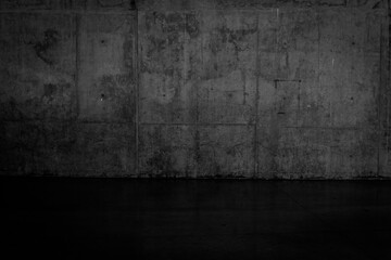 Grungy dark concrete wall and wet floor