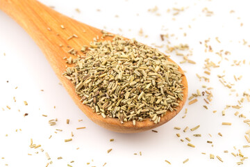 Dried rosemary leaves in wooden spoon