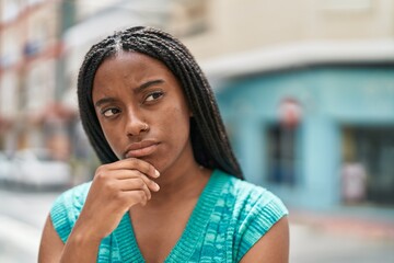 African american woman standing with doubt expression at street