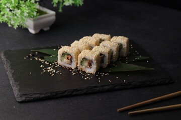 Sushi rolls on black background with salmon cheese and fish
