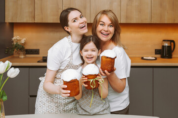Christ is risen! grandmother, mother and child with Easter cakes are preparing for the holiday