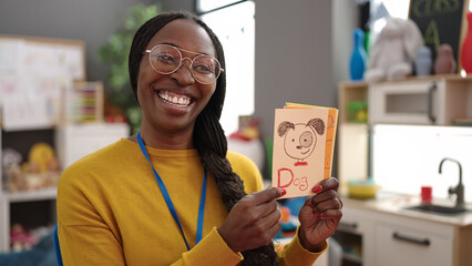 African woman preschool teacher on a vocabulary lesson at kindergarten