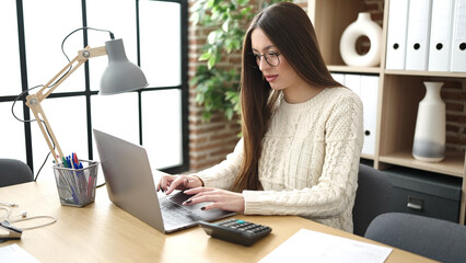 Young beautiful hispanic woman business worker using laptop working at office