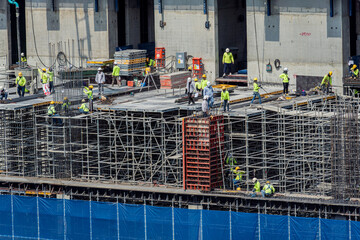 Concept of laborers working on modern construction site