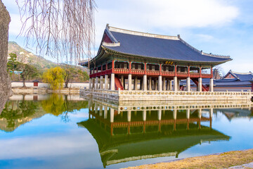 Fototapeta na wymiar View of Gyeonghoeru, a royal banquet hall at Gyeongbokgung Palace with blue sky and lake in the background