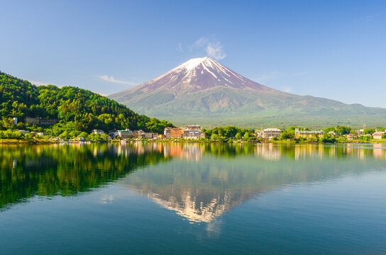 View of Lake Kawaguchiko with Mt Fuji in the background and its reflection. On a clear blue sky during spring season in Japan