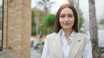 Young beautiful hispanic woman smiling confident standing at street