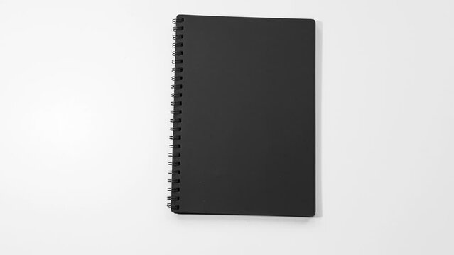 Stop motion animation concept. Close-up of black notebook on white background.