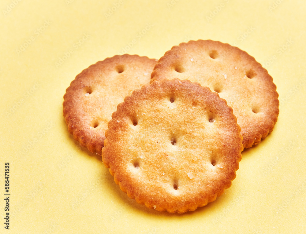 Poster  Delicious group of salty biscuits over isolated yellow background