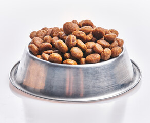  Delicious bowl of dog food balls over isolated white background