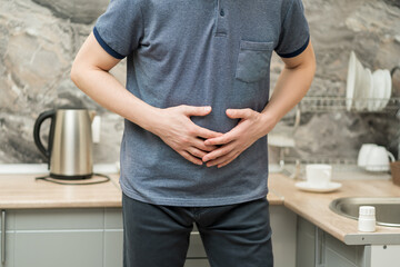Stomach ache, man with abdominal pain suffering at home