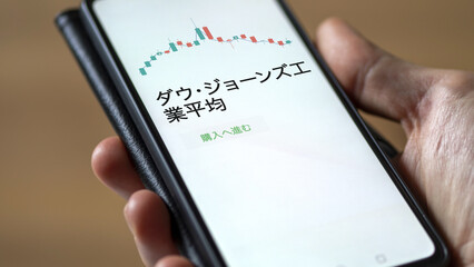 Investor analyzing an ETF. Funds stocks exchange ETFs Japanese text: Dow Jones Industrial Average, buy. ダウ・ジョーンズ工業平均 証券取引所 投資 shares