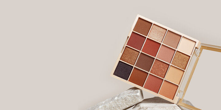Eyeshadows palette mock up on stone stand. Beauty product cosmetic powder for make up eye, beige brown color scheme, matte and shimmer tints. Cosmetic product minimal style, banner empty space