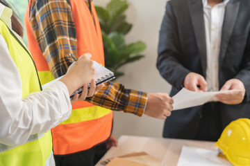 Builder team, hand of asian young engineer man and architect woman are discussing construction and...