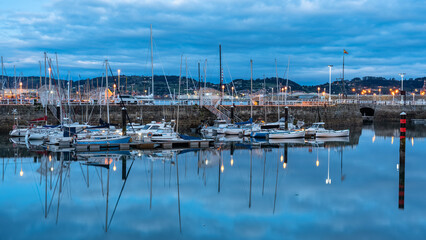 Fototapeta na wymiar Gijon Marina at sunrise with the quiet boats docked at the docks, Asturias, Spain.