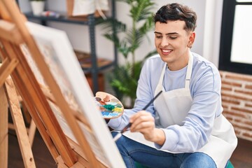 Young non binary man artist smiling confident drawing at art studio