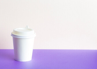 Paper Coffee glass with on a lilac background. Takeaway,