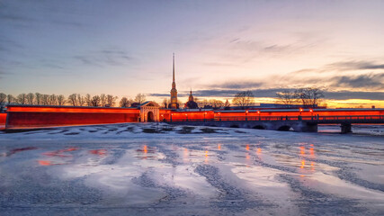Saint-Petersburg city center at dusk. Spring evening in St. Petersburg. Panoramic view of the Peter and Paul Fortress in the distance at sunset, city life, postcard view of the evening city.