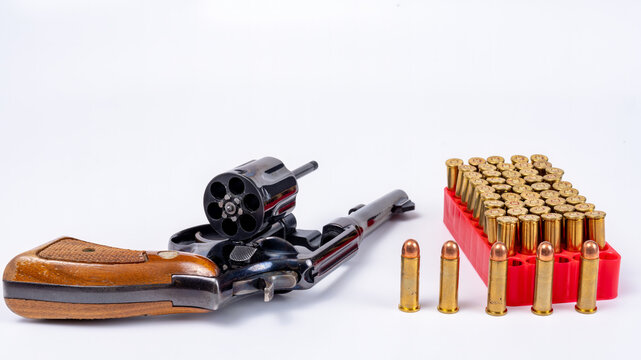 Handgun with ammunition on a white background