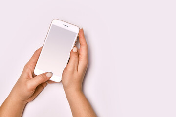 Female hands holding modern cellphone. Close up of woman hands holding smart phone with blank screen. Empty smartphone white screen ready for your app to be placed isolated on white background.