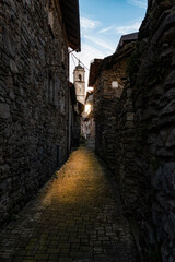 Fototapeta na wymiar Old street in an Italian village of Lake Como with sunset colors