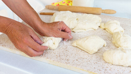 Chef kneading the dough on table Preparation of fresh and tasty homemade pastries. Unhealthy lifestyle, delicious fattening food concept photo. 