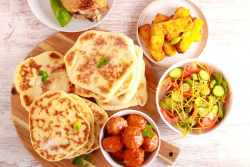 meal with meatballs, salad and flatbreads