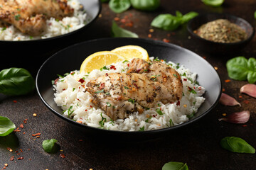 Grilled Chicken thighs served with rice in a black bowl