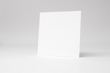 A blank square white paper on white background