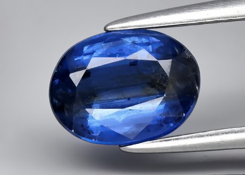 Natural gemstone blue kyanite on gray background