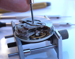 watchmaker repairing a watch mechanism