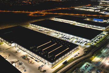 Aerial view of a warehouse of goods at night. Aerial view of industrial area, logistics warehouses...