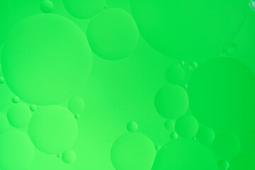 Abstract background with green oil circles on the water.